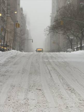 A bus makes its way over a hill on the Upper East Side. Amazingly, buses and subways with only a few minor exceptions and termporary outages on the 7 and Q line keep running.