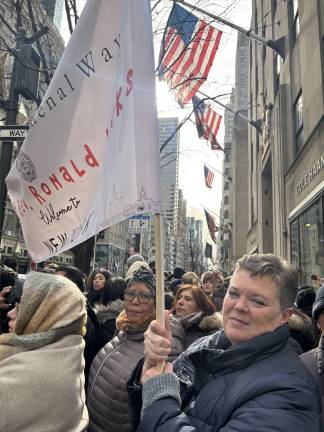 Caitlin Mullan said she is a former drug addict who found Jesus, married and had ten kids. “We’re here to welcome the new archbishop,” she said as she stood in the bitter cold holding a banner from St. Gabriel’s parish.