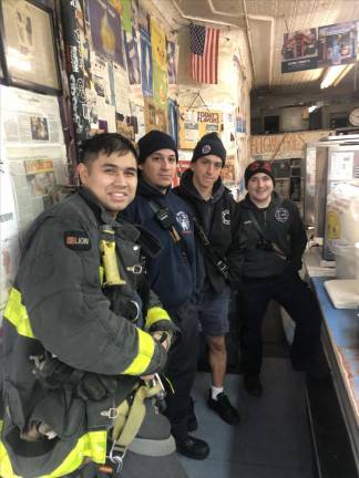 Firefighters from Engine 33/Ladder 9 (from left) John Acevdo, Joe Richardo, Vinny Lupes and Brandon Timmins on Great Jones Street in NOHO were among many neighborhood residents who trekked to the East Village for morning coffee in the days after the attack to show support for Ray Alvarez, the owner of Ray’s Candy Store who was attacked in the early morning hours of Jan. 31. Photo: Keith J. Kelly