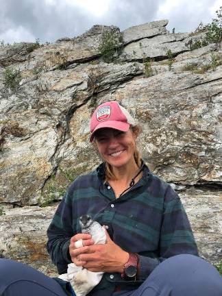 Taylor in the field with a puffin. They're completely adorable, she says.