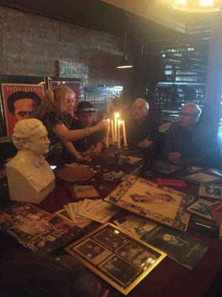 Dorothy Dietrich lights the candelabra before leading the s&#xe9;ance with a few moments of silence. Photo: Carson Kessler