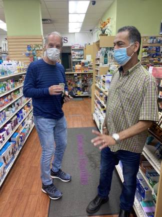 Frank Schneiger (left) and Khan in the pharmacy. Photo: Stephan Russo