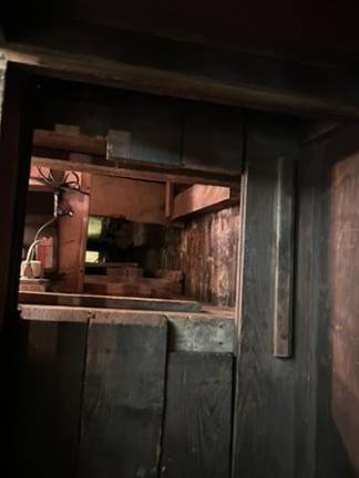 The 15-foot passageway descends to the ground floor of the house, barely fitting one person in at a time