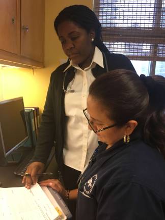 Claudia Paul, standing. Photo: Bernard White, Visiting Nurse Service of New York
