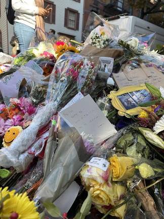 A card amongst the flowers saying, “The one where we lost a friend.”