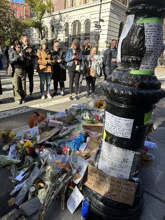 Pedestrians stopping to take pictures and commemorate the late actor Matthew Perry