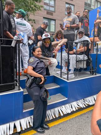 Cop gets her photo taken with Jordan Clarkson at start of Knicks parade.
