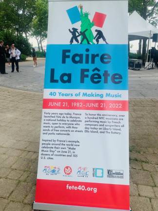 Make Music Day New York started in Battery Park. Here, a banner notes the history of the day, always June 21, when 5,000 musicians play at 140 venues all over NYC for free. Photo: Ralph Spielman