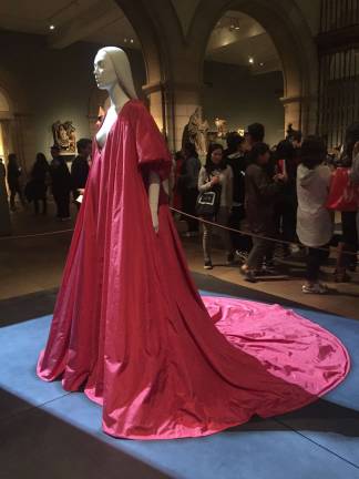 Crimson splendor in the Medieval Sculpture Hall: Pierpaolo Piccioli&#x2019;s design for Valentino, &quot;Evening Dress,&quot; autumn/winter 2017-18 haute couture. Red silk taffet. Valentino S.p.A. (Italian, founded 1959). Pierpaolo Piccioli (Italian, born 1967). Courtesy Valentino S.p.A. Hair by Shay Ashual. Photo: Val Castronovo