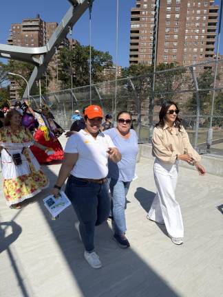 Parkies Tricia Shimamura and Iris Rodriguez-Rosa cross the bridge, a parade in front of and behind them.