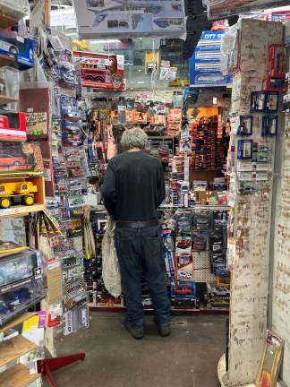 After descending the store stairs, you face the desk, visually embellished by the merchandise on hand at virtually level of vision.