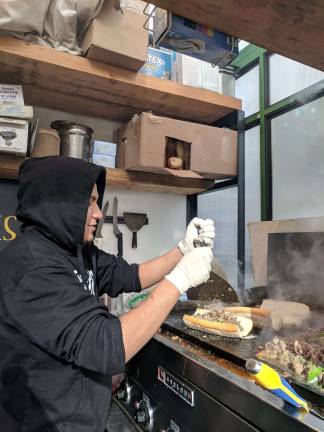 Freddy Rojas preparing a cheesesteak at Truffleist in Bryant Park. Photo: Liz Hardaway
