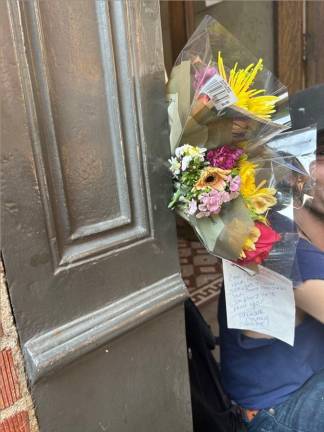 Flowers left on the front entrance of the apartment building to Antonio Fierro with a note from someone named Tanisha. Photo: Alessia Girardin