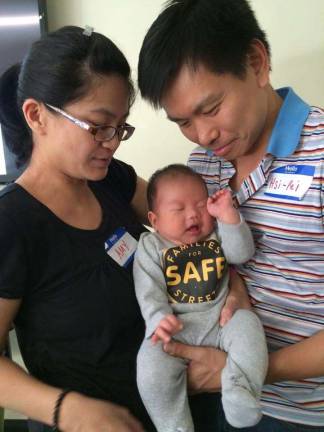 Amy Tam-Liao and her husband, Hsi-Pei Liao, whose daughter Ally died in a traffic accident. They are pictured with their new baby.