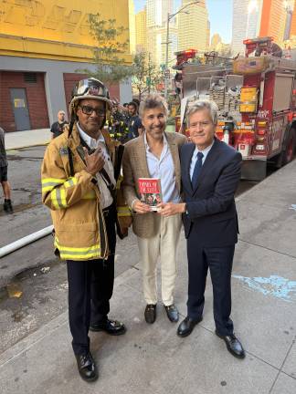 Author Michael Grynbaum (center) poses with Manhattan Borough President Brad Hoylman-Sigal and a firefighter on Sept. 15 after a fire erupted in the building where the Borough Book Club was going to feature the author’s new book, “Empire of the Elite” about the Condé Nastempire. He’s been rescheduled for Oct. 1.