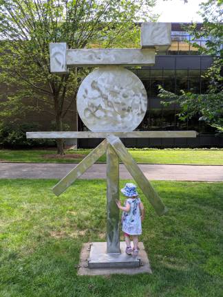A child explores a sculpture on the Princeton University campus.