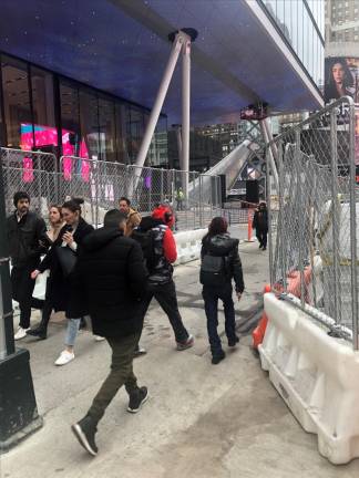 <b>While the main entrance is finally open on Seventh Ave. and 32nd St., there is still plenty of finishing work going behind the construction fencing adjacent to the main entrance.</b> Photo: Keith J. Kelly