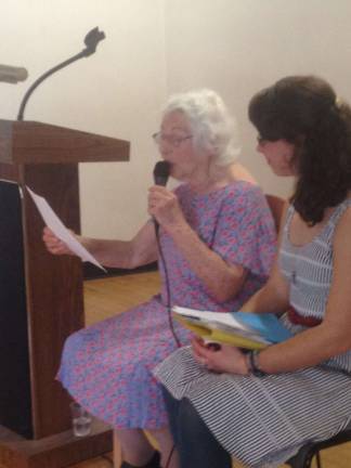 Esther Lazarson, left, reading from one of her poems.