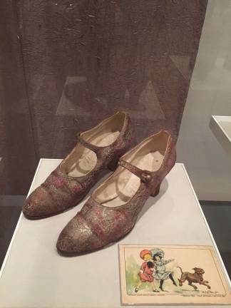 Unidentified maker. Mary Jane shoes, ca. 1926. Silk and metallic patterned fabric, embossed metal buttons. Stuart Weitzman Collection. Photo:&#xa0; Val CastronovoRichard F. Outcault (1863-1928). Postcard, 1906. Color lithograph. New-York Historical Society. Photo:&#xa0; Val Castronovo