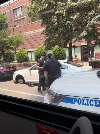 Police investigate the aftermath of a tire theft on East 71st Street near York Avenue.