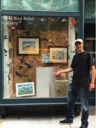 David Opie stands in front of the window gallery installation. Photo courtesy of David Opie