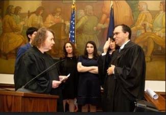 <b>Lyle Frank (right) is sworn as a new NY Supreme Court judge by retired Judge Kathryn Freed ( left) while his wife Elyssa Kates, daughter Cathryn, son Gavin, and sister Samantha Feldman</b> look on. Photo: Rachel Marks/Orah Photo