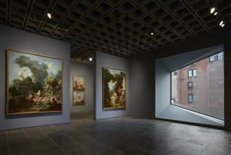 Room 24: Four grand panels of Fragonard’s series “The Progress of Love” are shown together at Frick Madison in a gallery illuminated by one of Marcel Breuer’s trapezoidal windows. This view shows two of the 1771–72 paintings, with two later overdoors visible in the next gallery. Photo: Joe Coscia