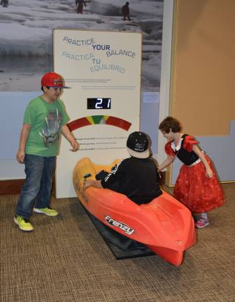 Fifth-grade students from New York City Public School 276 try out a kayak balancing activity at the imagiNATIONS Activity Center grand opening ceremony on Thursday, May 17, 2018. Photo: Jason DeCrow/AP Images for Smithsonian's National Museum of the American Indian 