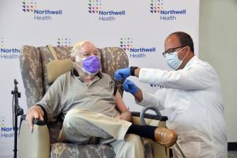 Dr. Matthew Harris, head of vaccine distribution at Northwell Health, administers a third shot of the Moderna vaccine to Arthur Magee, 81, an immune-compromised cancer patient from Brooklyn. Photo courtesy of Northwell Health