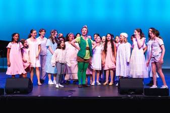 Camp Broadway’s 30th anniversary program presented songs and scenes from <i>Peter Pan</i> and <i>Catch Me If You Can</i> with an ensemble cast of 100 theater-loving kids from around the world. Featured player Katie Risko as Peter Pan performs with a group of Darling Children.