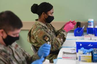 Medical members of the National Guard prepare Pfizer COVID-19 vaccines on February 24, 2021 at Medgar Evers College in Brooklyn, one of the New York State-FEMA mass vaccination sites. Photo: Kevin P. Coughlin / Office of Governor Andrew M. Cuomo
