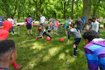 A group of kids play a ball game in the grass. Photo: NYC Parks / Daniel Avila