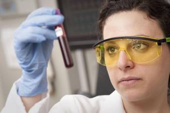 Checking a blood sample. Photo: National Eye Institute