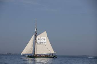 The Clearwater sloop (above) sailing south towards the Verrazzano-Narrows Bridge on the morning of the July 4th Sail Parade. Its sail reads, “Save the Clean Water Act,” as part of the organization’s efforts towards environmental advocacy.