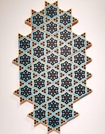Paper cutouts become tiles, Stars of David, or anything the viewer wants to make of them in &quot;It Is He Who Created You From A Single Soul&quot; by Dana Awartani. Photo: Adel Gorgy