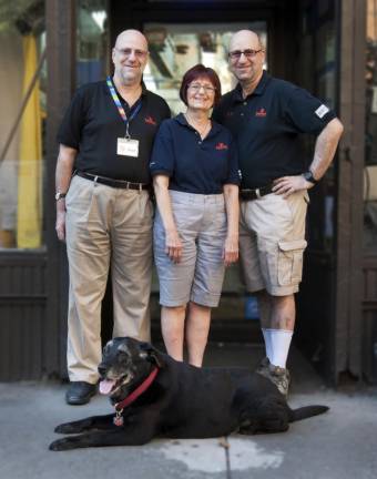 Bruce Stark, Ellen Gabe-Stark and Steven Stark with Bru, the store's mascot.