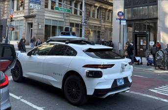 A Waymo robotaxi at Broadway and Walker Street, March 2026.