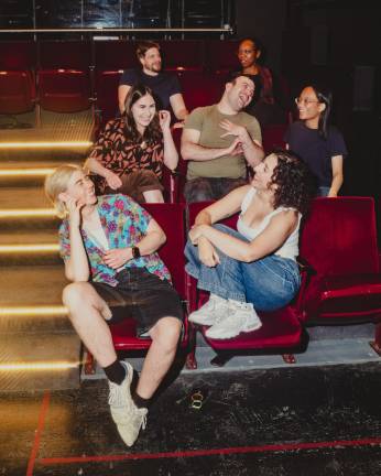 Queer Window members Loie Plautz, Sarah Franco, Marisa Winckowski, Aran Abilock Clemmons, Seyoung Kim, Zoe Johnson and Matt Grote laugh together at the Upright Citizens Brigade.