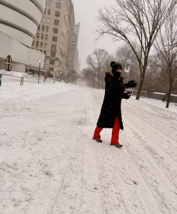 Heather Stein crosses Fifth Ave on Jan. 25 as the storm was turning to sleet and freezing rain.