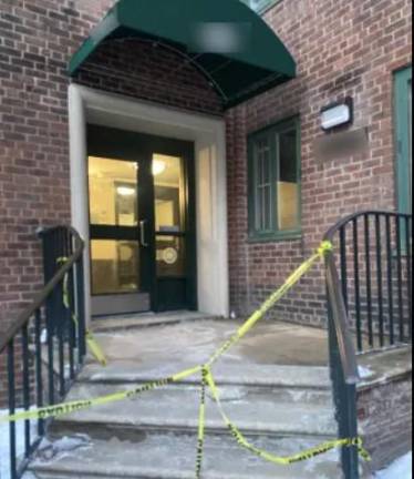 Police tape outside the building where a brutal rape of a 14-year-old girl occurred on Jan. 29 by a man who police said “piggybacked” into the building after the teen opened the door with her key card.