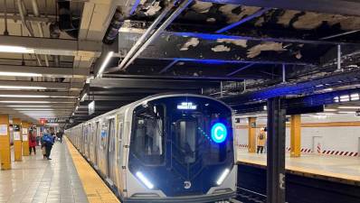 The NYC Transit’s newest train, one of two R211T open gangway trains that will ply the C train local line on the west side, pulls into the Eighth Avenue 14th Street Station. Photo: Ralph Spielman