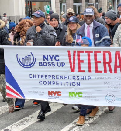 Mayor Adams with coffee cup and Veterans’ Services Commissioner James Herndon in pink tie.