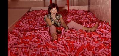 Karen Rempel frolics in the sprinkle pool at the Museum of Ice Cream.