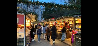 After-work crowds peruse the unique handcrafted gifts at the Union Square Holiday Market.