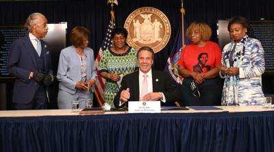Gov. Andrew M. Cuomo signs an executive order on June 12 requiring local police agencies, including the NYPD, to reinvent and modernize police strategies based on community input. With Rev. Al Sharpton, Senate Majority Leader Andrea Stewart-Cousins, Assembly Leader Carl Heastie, Valerie Bell, the mother of Sean Bell; Gwen Carr, the mother of Eric Garner; and Hazel N. Dukes, President of the NAACP New York State Conference.