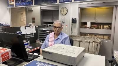 Angie Serrano at her window where she helped the UWS neighborhood for the past 19 years in a postal career that spanned 39 years. <i>The Spirit </i>caught up with her on her last day on the job.