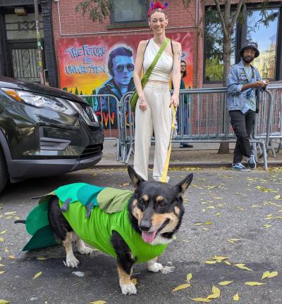 Smiling dog mom and caterpillar dog outside a Joe Strummer mural on East 6th Street during the Tompkins Square Park Dog Halloween parade in the East Village on Oct. 19.