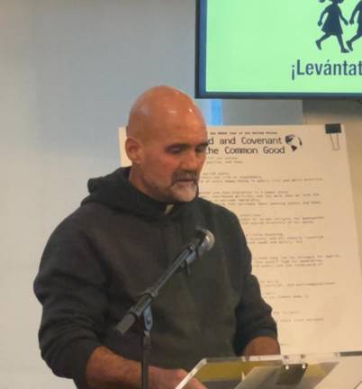 Graf speaking at a Dec. 2 reception in honor of his journey, where he called immigrants his “brothers and sisters.”