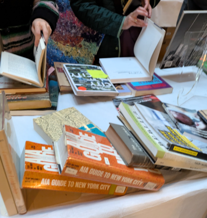 A book table including copies of the <i>AIA Guide to New York City</i>.