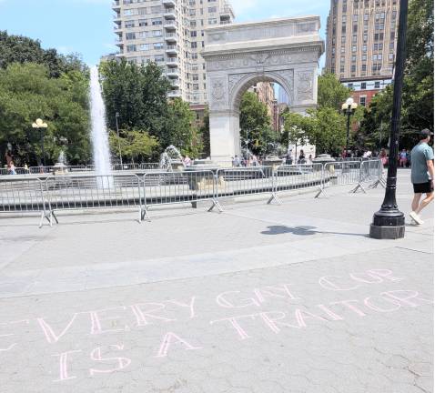 Pink chalk graffiti at Washington Square Park: “Every gay cop is a traitor.”